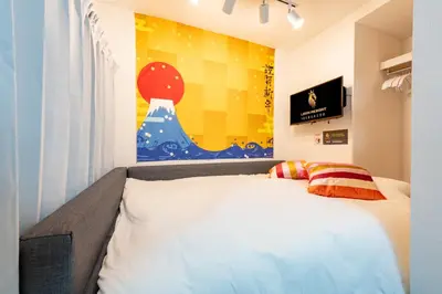 a bedroom with a white bed and a painting on the wall at A 3rooms MAX8people 6min Shinjuku 11min Shibuya 12min walk Ikebukuro LEON RESORT IKEBUKURO traditional Japanese room \u6c60\u888b \u6700\u59278\u540d in Tokyo