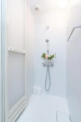 a white bathroom with a shower with a flower holder at A 3rooms MAX8people 6min Shinjuku 11min Shibuya 12min walk Ikebukuro LEON RESORT IKEBUKURO traditional Japanese room \u6c60\u888b \u6700\u59278\u540d in Tokyo