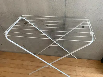 a metal shelf in the corner of a room at Shirokane Apartment Hotel 3 in Tokyo