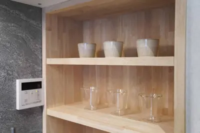 a wooden shelf with glasses on it at Real Life IIDABASHI in Tokyo