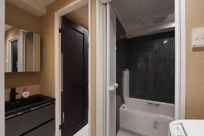 a bathroom with a toilet and a sink and a window at Real Life IIDABASHI in Tokyo