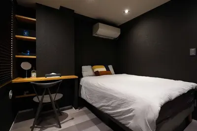 a small bedroom with a bed and a desk at Real Life IIDABASHI in Tokyo