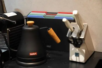 a black blender sitting on top of a counter at Real Life IIDABASHI in Tokyo