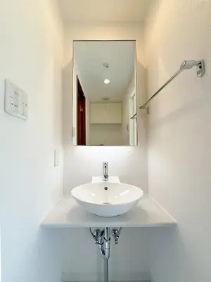 a white sink in a bathroom with a mirror at The Plars in Tokyo