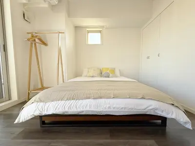 a bedroom with a bed in a white room at The Plars in Tokyo