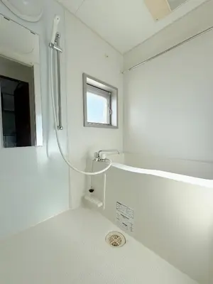 a white bathroom with a shower and a sink at The Plars in Tokyo