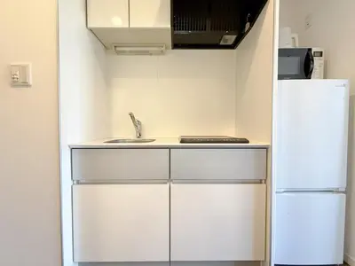 a kitchen with a sink and a refrigerator at The Plars in Tokyo