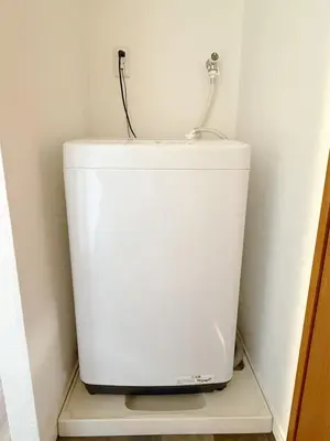 a white water tank in a corner of a room at The Plars in Tokyo
