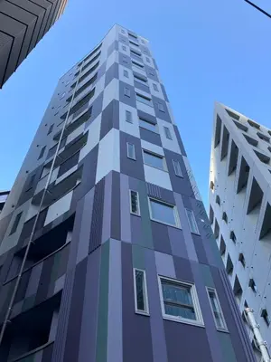 a tall building with blue sky in the background at HOTEL LiVEMAX Mita Ekimae in Tokyo