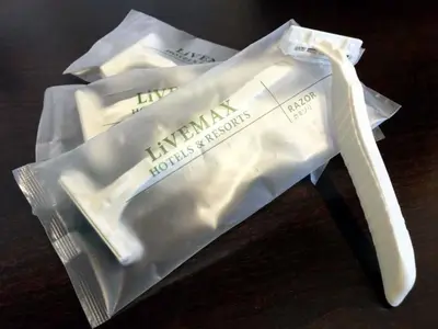 a cell phone in a plastic bag on a table at HOTEL LiVEMAX Mita Ekimae in Tokyo
