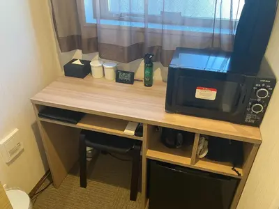 a desk with a microwave and a coffee maker at HOTEL LiVEMAX Mita Ekimae in Tokyo