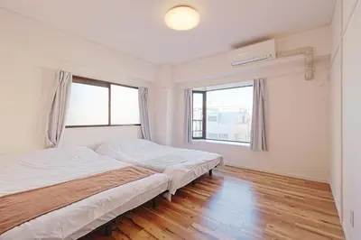 a bedroom with two beds and two windows at V Close to Shinjuku Kabukicho Korean Town FrWIFI K in Tokyo