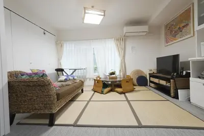 a living room with a couch and a table at Ayaka's House in Tokyo