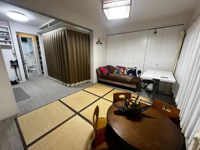 a living room with a table and a couch at Ayaka's House in Tokyo