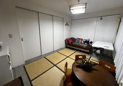 a living room with a table and a couch at Ayaka's House in Tokyo