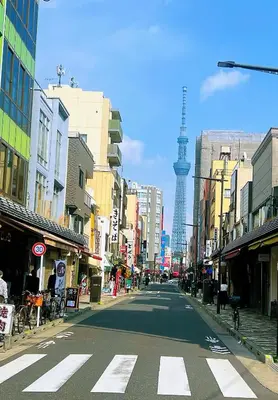 an empty city street with a tower in the background at Ayaka's House in Tokyo