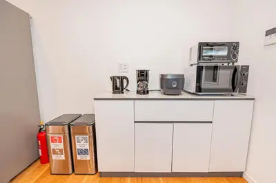 a white counter with a microwave and a toaster oven at Arashi hotel \u5d50\u30db\u30c6\u30eb in Tokyo