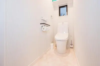 a white bathroom with a toilet and a window at Arashi hotel \u5d50\u30db\u30c6\u30eb in Tokyo