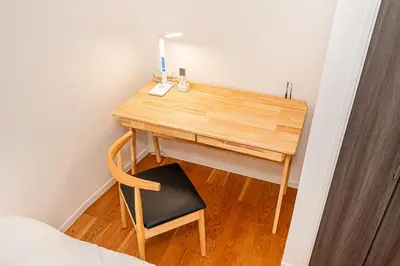 a wooden desk with a chair and a lamp at Arashi hotel \u5d50\u30db\u30c6\u30eb in Tokyo
