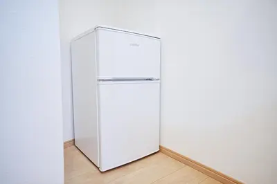 a white refrigerator in a corner of a room at Manere in Tokyo
