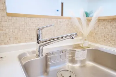 a kitchen sink with a chrome faucet at Manere in Tokyo