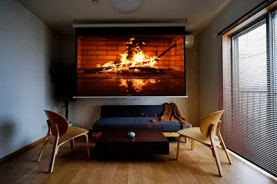 a living room with a fire in a fireplace at Manere in Tokyo