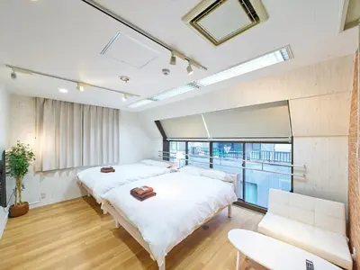 a bedroom with two beds and a large window at Shinbashi Hotel Sho - Vacation STAY 82923v in Tokyo