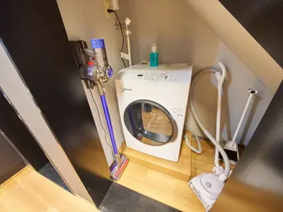 a washer and dryer in a corner of a room at Shinbashi Hotel Sho - Vacation STAY 82917v in Tokyo