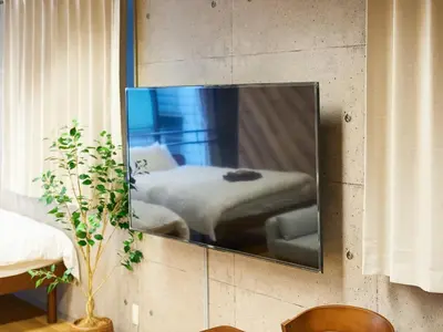a mirror on a wall with a bed in a room at Shinbashi Hotel Sho - Vacation STAY 82917v in Tokyo