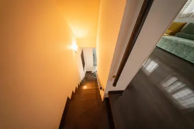 a hallway with a stairway leading to a room at Hotel Yuga - Vacation STAY 82984v in Tokyo