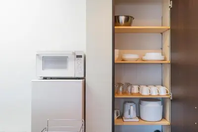 a kitchen with a refrigerator and a microwave at Hotel Yuga - Vacation STAY 82984v in Tokyo