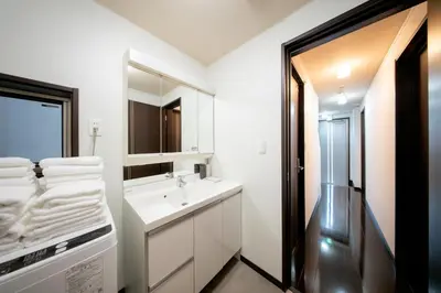 a white bathroom with a sink and a mirror at Hotel Yuga - Vacation STAY 82984v in Tokyo
