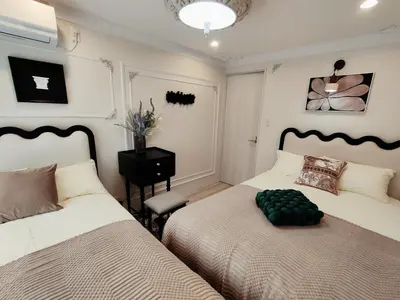 a bedroom with two twin beds and a table at ds' 2ROOMS NEW APT Max 6P 临近商业街 2室1厅1卫生间 交通便利 最大6人 Max 6P 方便到达新宿 涉谷 表参道 池袋 in Tokyo