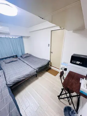 a bedroom with a bed and a desk and a table at Shinjuku West entire house in Shibuya District in Tokyo