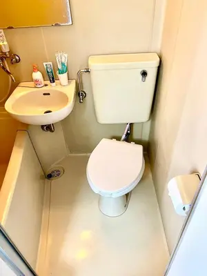 a small bathroom with a toilet and a sink at Shinjuku West entire house in Shibuya District in Tokyo
