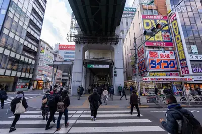 a group of people crossing a street in a city at YIYou Japan\u79cb\u8449\u539f302 in Tokyo
