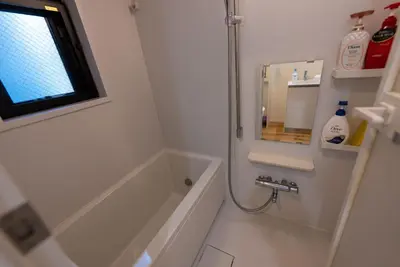 a bathroom with a tub and a sink and a mirror at YIYou Japan\u79cb\u8449\u539f302 in Tokyo