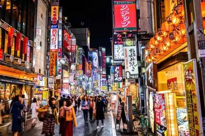 a crowd of people walking down a busy city street at night at Shinjuku city4\u4eba\u53efTV\u4ed8\u304d in Tokyo