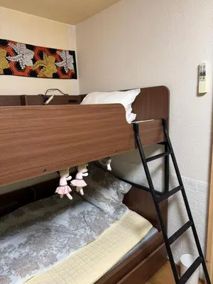 a bunk bed with pink shoes on top of it at \u7ae5\u7ae5\u6c11\u5bbf in Tokyo