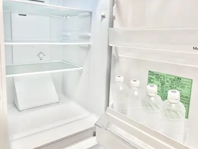 a refrigerator filled with lots of bottles of water at TOKYO SPA Premier UENO in Tokyo