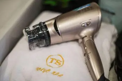 a hair dryer sitting on top of a towel at TOKYO SPA Premier UENO in Tokyo