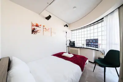 a bedroom with a bed and a desk and a window at SAKURA Residence\u76ee\u9ed2 301 in Tokyo