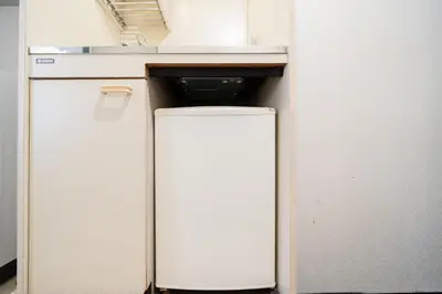 a white refrigerator in a kitchen with a sink at SAKURA Residence\u76ee\u9ed2 301 in Tokyo