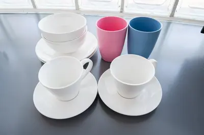 a group of white cups and saucers on a table at SAKURA Residence\u76ee\u9ed2 301 in Tokyo