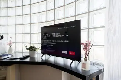 a flat screen tv sitting on a table in front of a window at SAKURA Residence\u76ee\u9ed2 301 in Tokyo