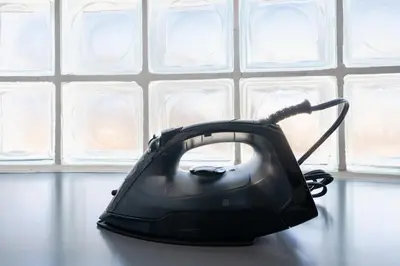 a black phone sitting on a table in front of a wall at SAKURA Residence\u76ee\u9ed2 301 in Tokyo