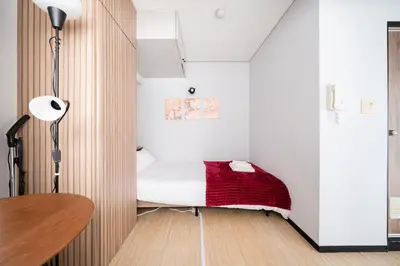 a small bedroom with a bed and a table at SAKURA Residence\u76ee\u9ed2 307 in Tokyo
