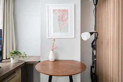 a table in a kitchen with a vase on it at SAKURA Residence\u76ee\u9ed2 307 in Tokyo