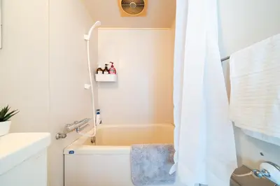 a bathroom with a shower with a toilet and a sink at SAKURA Residence\u76ee\u9ed2 307 in Tokyo