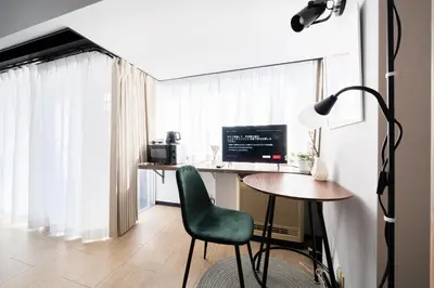 a room with a desk with a computer and a green chair at SAKURA Residence\u76ee\u9ed2 307 in Tokyo